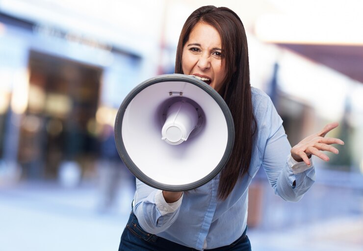 businesswoman trying bullhorn